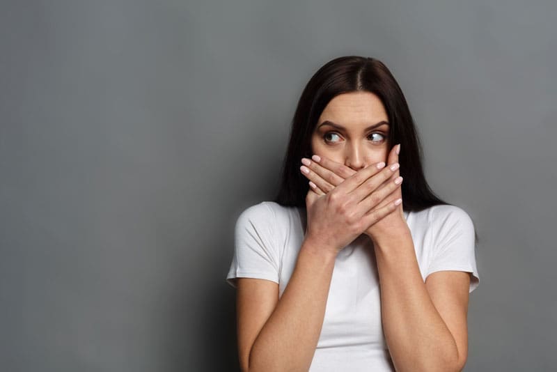 Dental Patient Covering Her Mouth