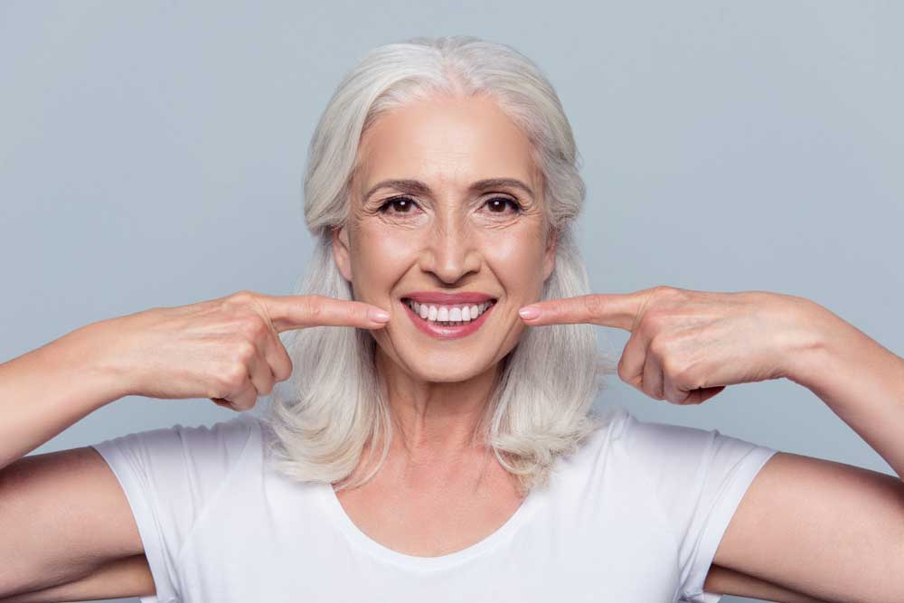 dental patient smiling after all on 4 dental implants