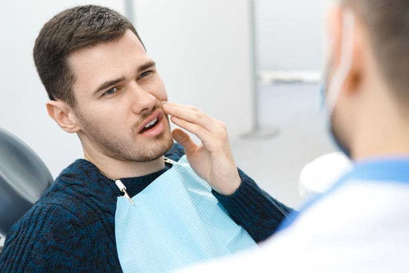 Dental Patient Suffering From Mouth Pain On A Dental Chair, In Harrisonburg, VA